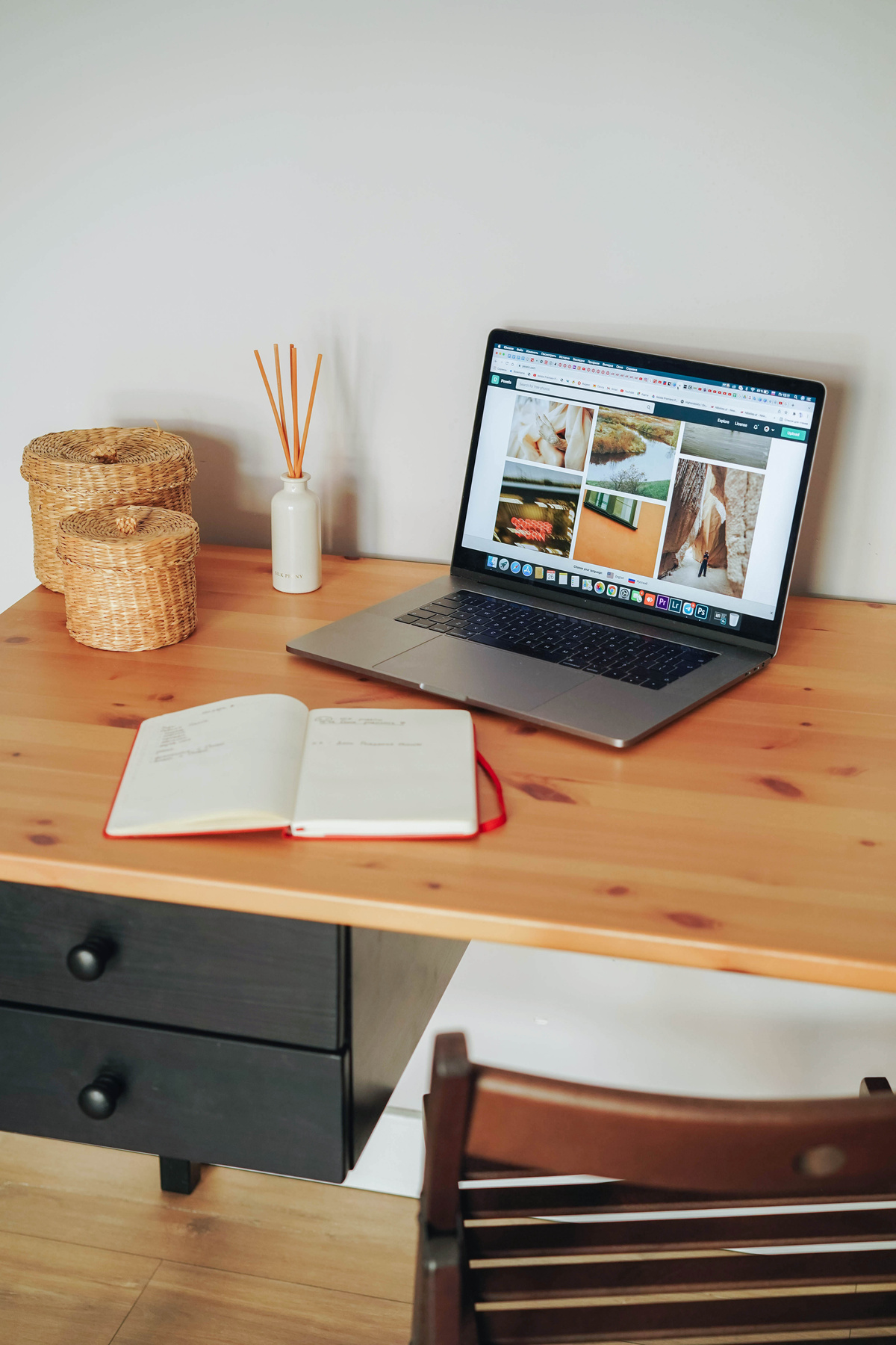Laptop and Notebook on Wooden Desk